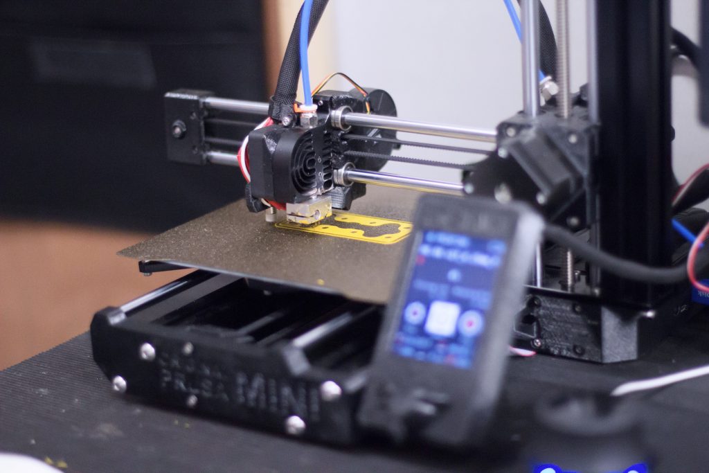 A 3D printer producing a part